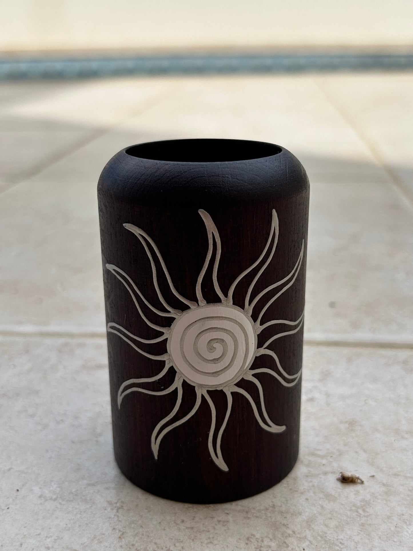 Candle holder with a sun