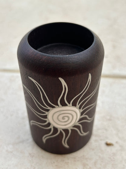 Candle holder with a sun